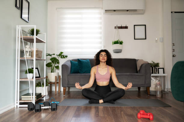 istock Good-looking female yogi practicing yoga at home 1288001225