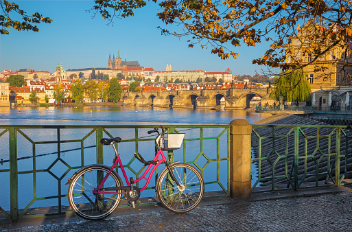 Prague - The rental bike on the waterfront,Charles Bridge,  Cathedral in the background.