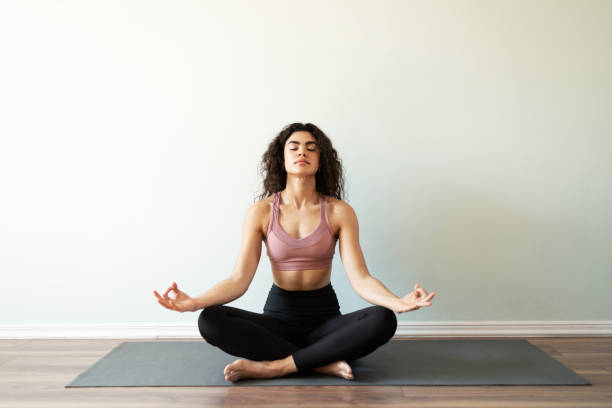 istock Beautiful young woman doing a meditation exercise 1288006030