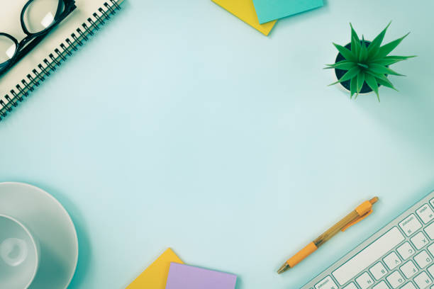 istock Top View Modern Office Desk on Blue Minimalist Background in Vintage Tone 1288016563