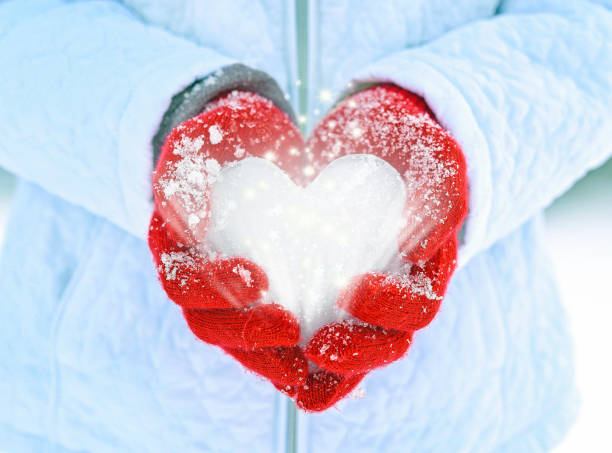 istock ice heart in red gloves with sparkles 1288022755