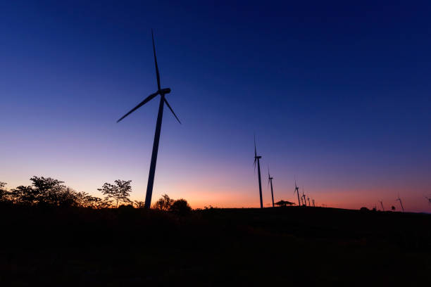 istock wind turbines park for make the electric power from wind in sunrise time 1288025279
