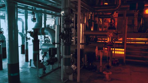 istock Large pipes in a factory in red and blue lighting 1288027537