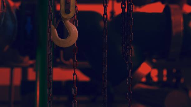 istock Hook and chains hang inside the factory at night 1288027618