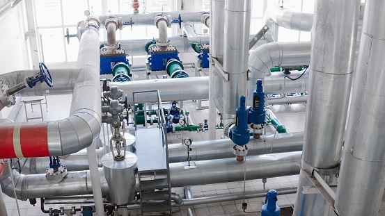 Large pipes of heating equipment in a boiler room