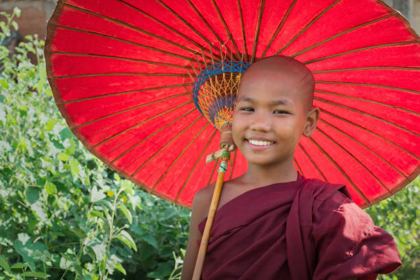 bright happy smiling birman novice monk child portrait myanmar - parasol umbrella asian ethnicity asian culture photos et images de collection