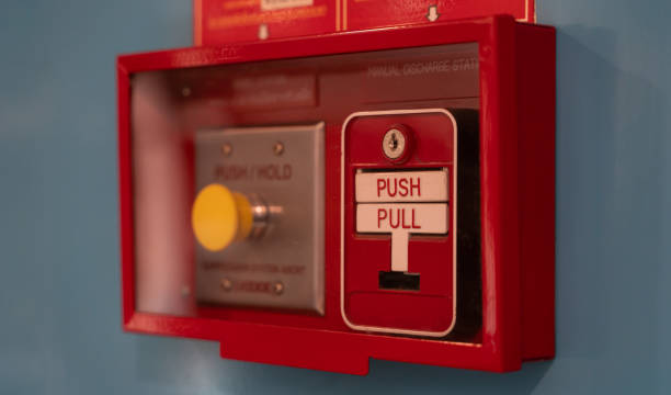 istock Fire alarm switch on wall. Emergency alarm button installed in a building. 1288035368