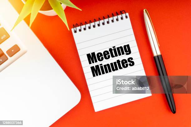 Meeting Minutes Text With Notepad Laptop Fountain Pen And Decorative Plant On Red Background Stock Photo - Download Image Now