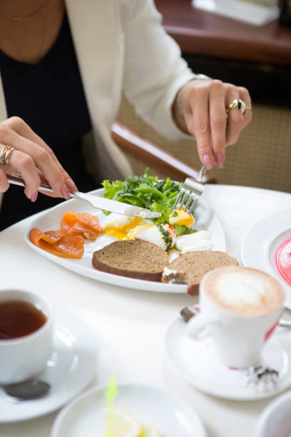 istock Woman eating poached egg for breakfast 1288038173