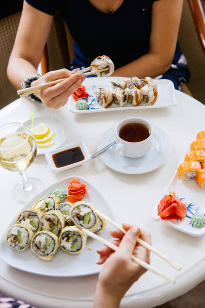 istock Two women eating japanese sushi rolls 1288038186
