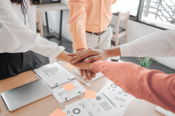 istock Businesspeople teamwork group putting their hands together agreement plan in meeting room, investment concept, success concept