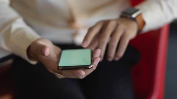 istock Businessman hands using smartphone while relaxed sitting in office room 1288039274