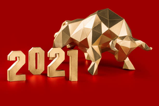 Golden volumetric paper bull and numbers 2021 on red Golden volumetric paper bull papercraft and numbers 2021 on a red background, symbol of the year chinese new year photos stock pictures, royalty-free photos & images