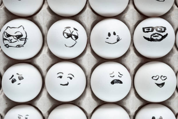 istock White eggs in cardboard box with different faces painted on them. Eggs with emotions. 1288041251