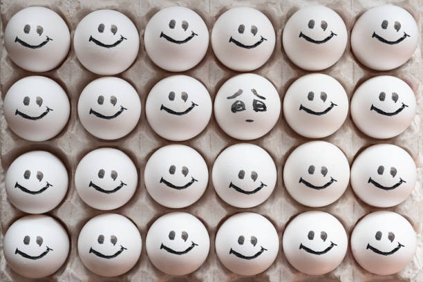 istock One egg with sad emotion among another eggs with happy emotions. Eggs with emotions. 1288041280