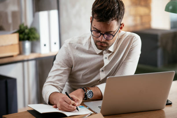 istock Businessman working in the office on his laptop. 1288042621