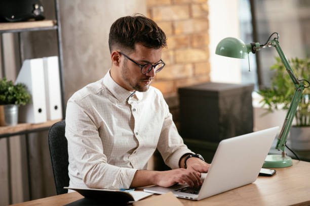 istock Businessman working in the office on his laptop. 1288042623