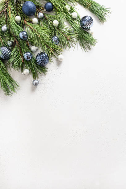 Christmas frame with blue balls and evergreen branches on white. Xmas Greeting card. Copy space.