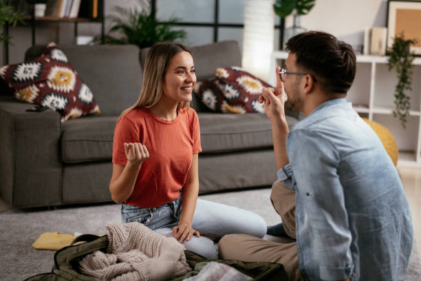 istock Loving couple packing clothes into travel bag. 1288045444