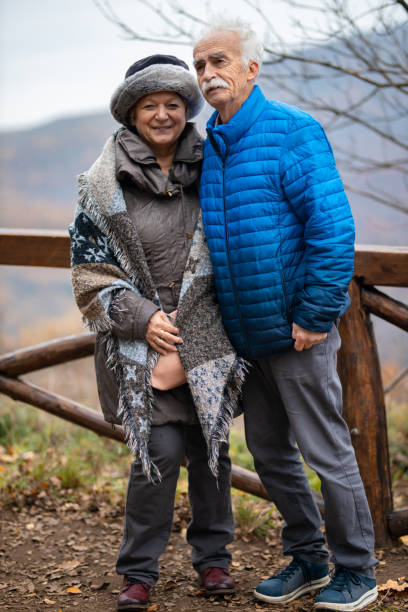 istock Embraced senior couple enjoying in autumn day while rest during hike 1288045898