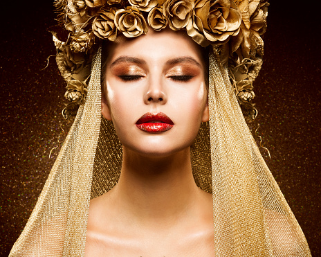 Crown Woman Golden Make up. Fashion Girl Portrait with closed Eyes. Bridal Gold Eye shadow and Lipstick Make-up. Dark shining background