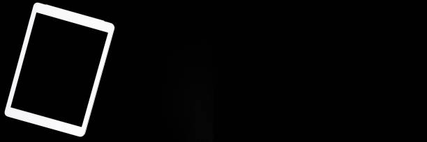 istock white tablet turned off on a black background. minimal black white concept. space for text. banner 1288049091