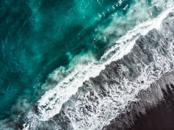 istock Soft wave of blue ocean on sandy beach. 1288051720