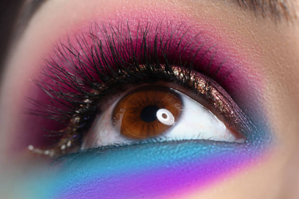 istock Beautiful brown eye with bright makeup looks up in closeup 1288052501