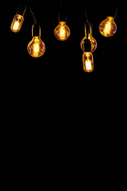 istock Classic Edisson bulbs backgound. Retro style bulbs. Vintage glowing light bulbs on a black background. 1288056690