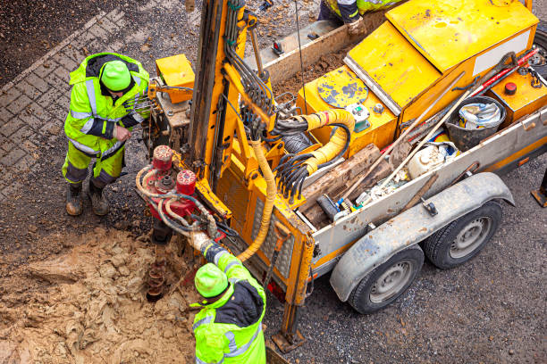 istock Surveyor examines the ground by drilling 1288057556