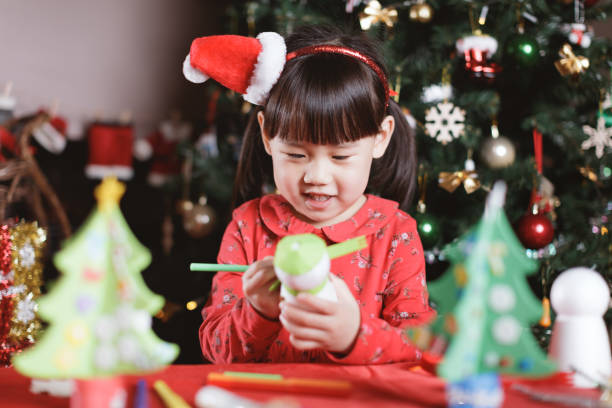 istock young girl making Christmas craft at home 1288057575