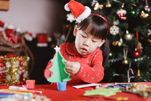 istock young girl making Christmas craft at home 1288057675