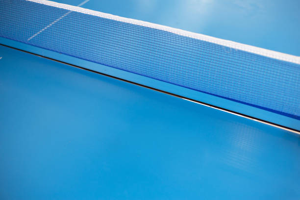 istock Net of table tennis ping pong on blue background. 1288058937