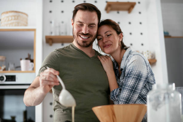 istock Husband and wife making pancakes at home. 1288062838