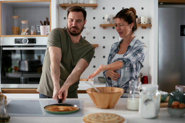 istock Husband and wife making pancakes at home. 1288063529