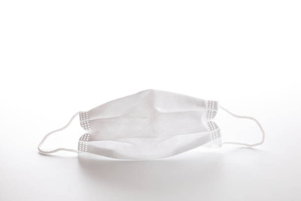 istock Used white mask isolated in white background 1288064658