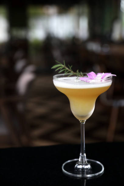 istock Pink Cocktail glass with ice at a bar counter 1288065393