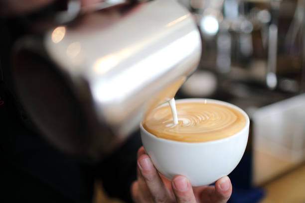 istock Male hands pouring milk and preparing to making cappuccino coffee 1288065817