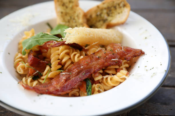 istock fusilli pasta with bacon italian food 1288067135