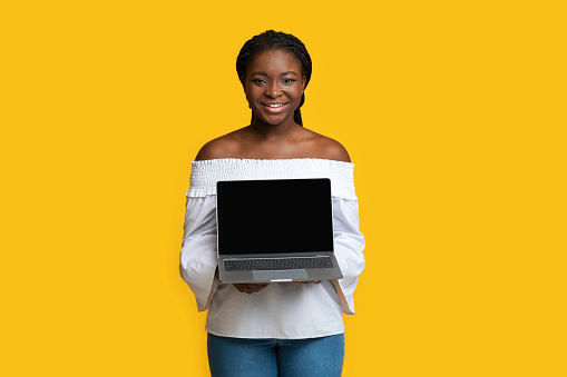 Mocku Of Laptop With Black Screen In Hands Of Smiling Black Woman