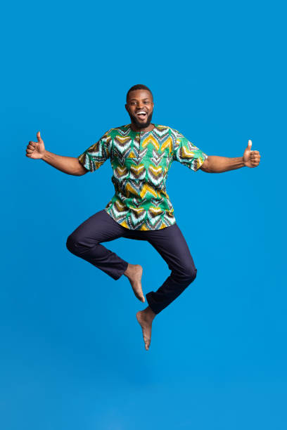 istock Emotional black guy showing happiness on blue background 1288067983