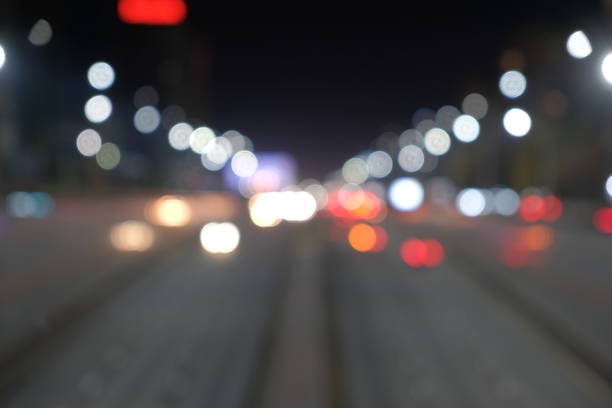 istock Blurred motion light of car headlamps headlights, soft focus.  Multicolor bokeh,blur focus. 1288069381