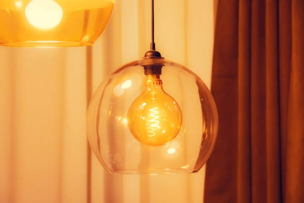 istock Retro style lamp inside electric spiral in warm light in double glass. 1288069474