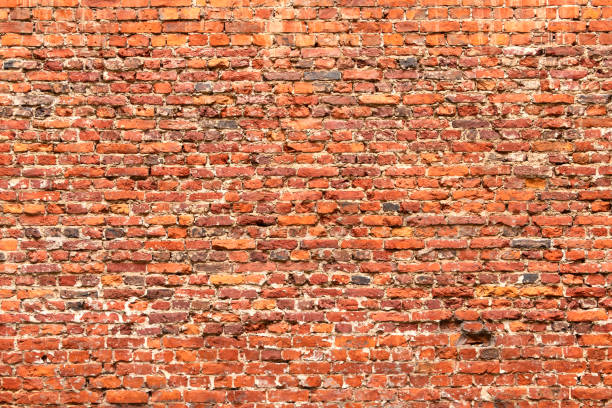 istock Brick wall made of old crumbling red bricks 1288070606