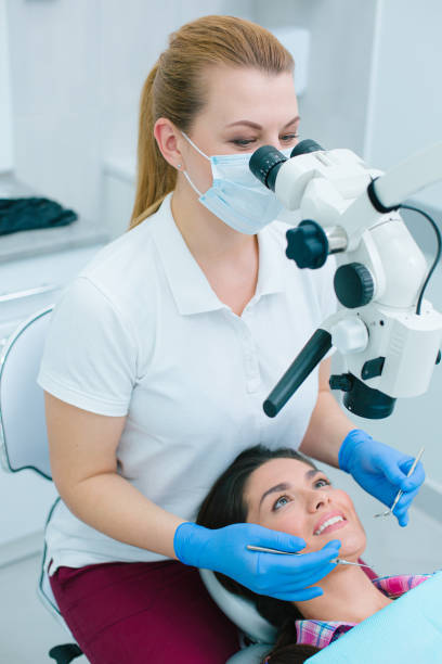 istock Cheerful patient undergoing teeth treatment with professional dentist 1288070850