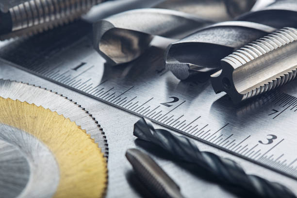 istock set of different drill bits,thread taps and mill cutters with ruler on steel plate background. Locksmithing deal. 1288071132