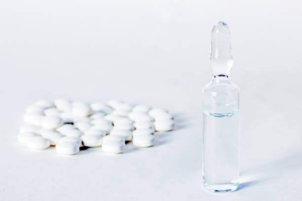 ampoule with vaccine and tablets stock photo