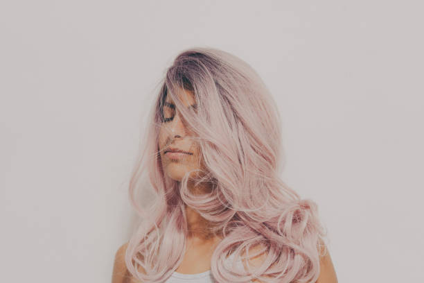 Portrait of a teenage girl with a pink hair, studio shot