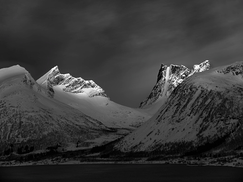 Dramatic black-white majestic Mt Cook rocky snow capped peak over Lake Pukaki in Tasman valley of New Zealand.