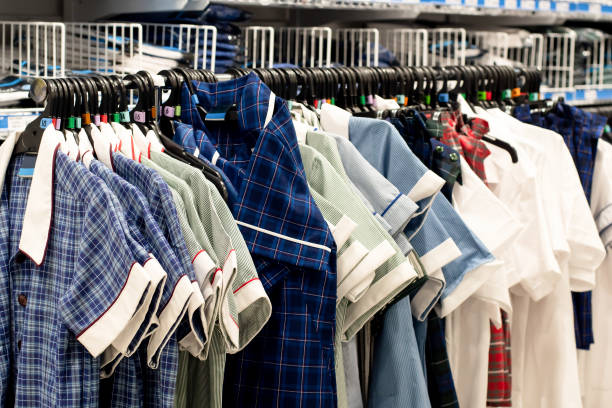Various colors school uniform dresses for girls on hangers on the rack at the shop. Back to school shopping in Australia Various colors school uniform dresses for girls on hangers on the rack at the shop. Back to school essential shopping in Australia school uniform stock pictures, royalty-free photos & images